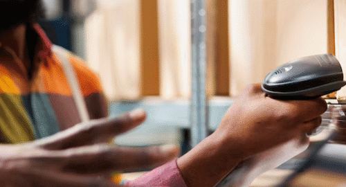Person using a barcode scanner in a warehouse.