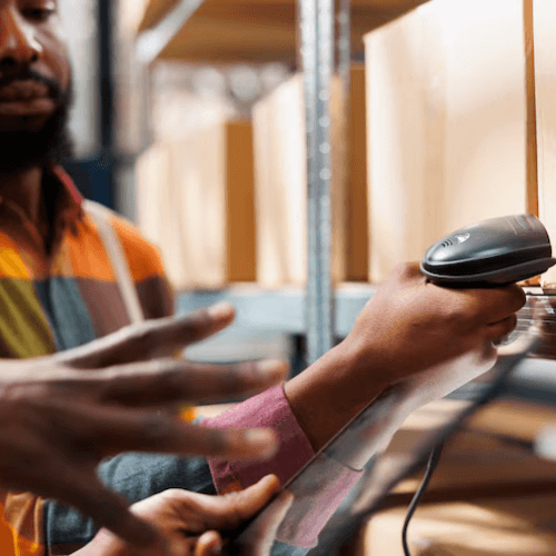 Person using a barcode scanner in a warehouse.