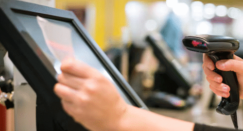 Choosing the Right POS Supplier for Bulk Purchases: A Complete Guide for Businesses 11 Person using a POS system with a barcode scanner.